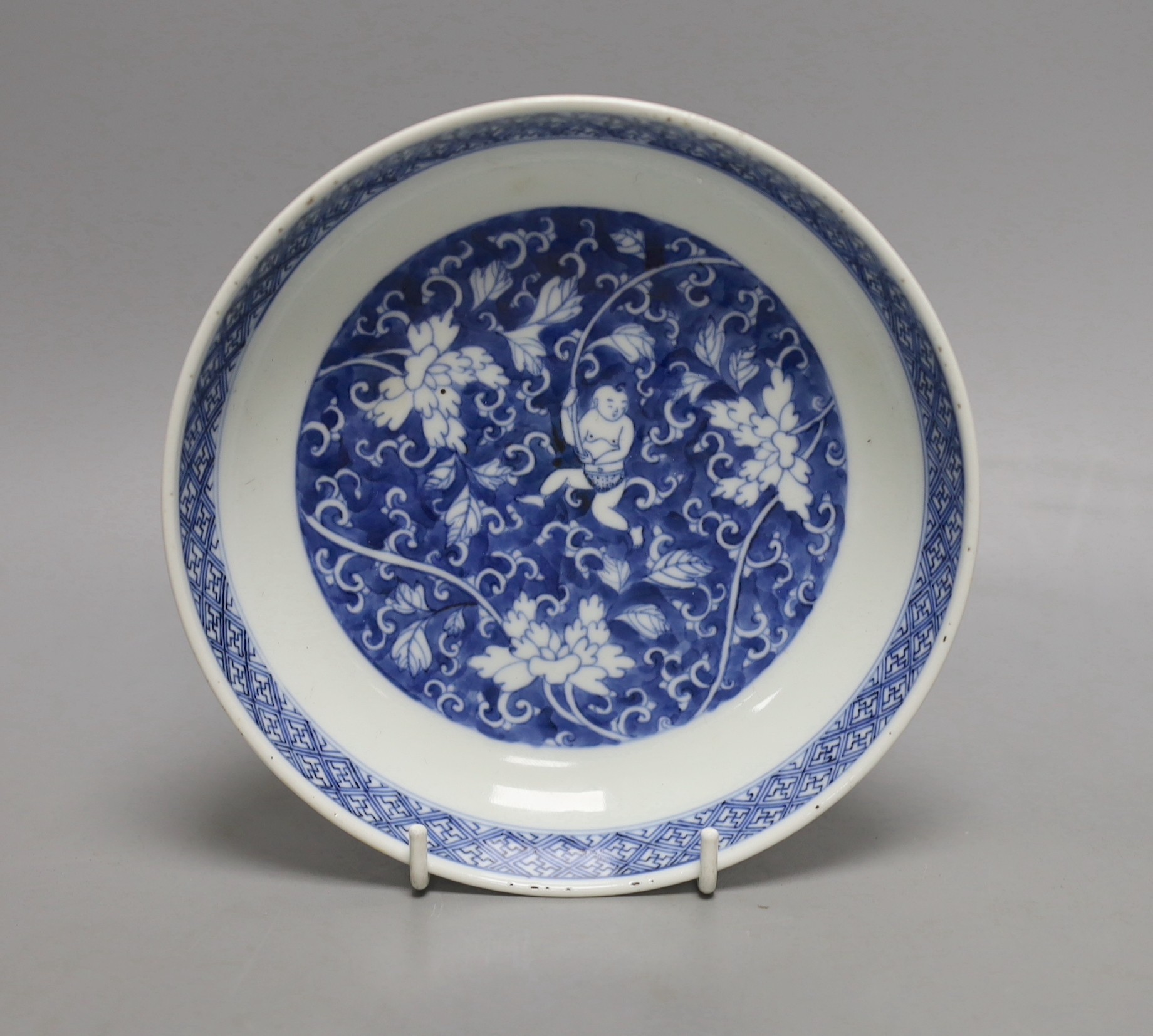 A Chinese blue and white saucer dish, Kangxi mark but later, 16cm diameter